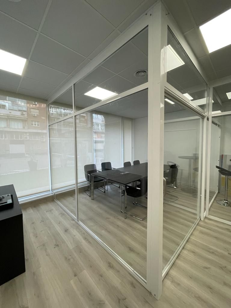 Una sala de conferencias con una mesa y sillas.