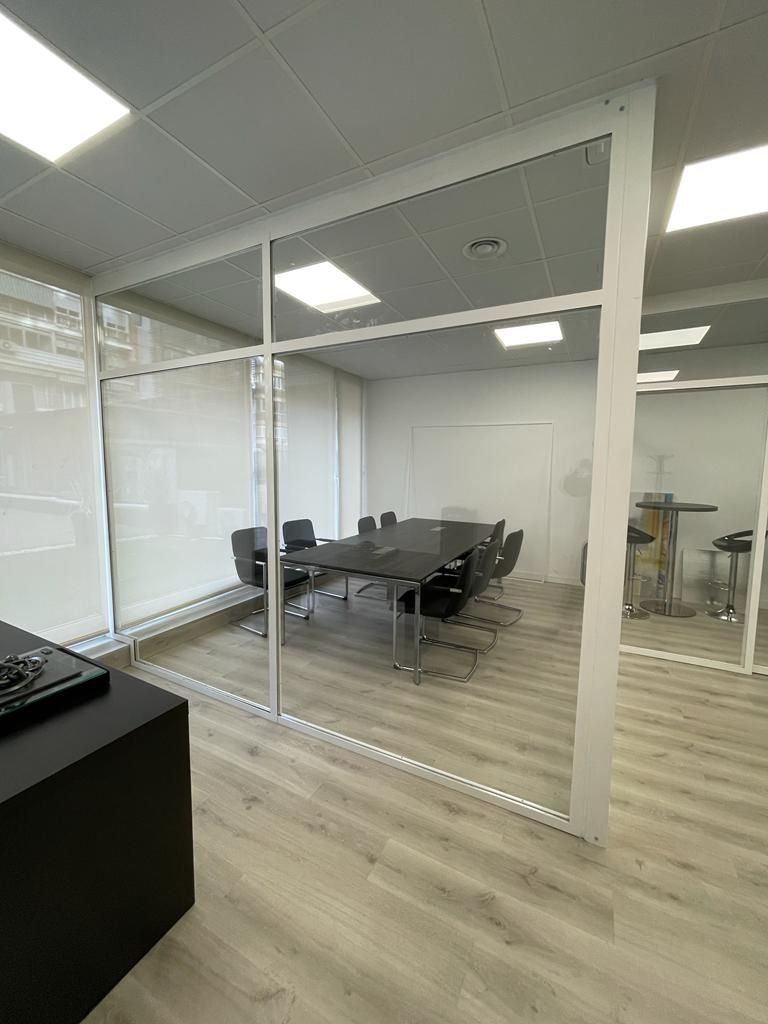 Una sala de conferencias con una mesa y sillas.