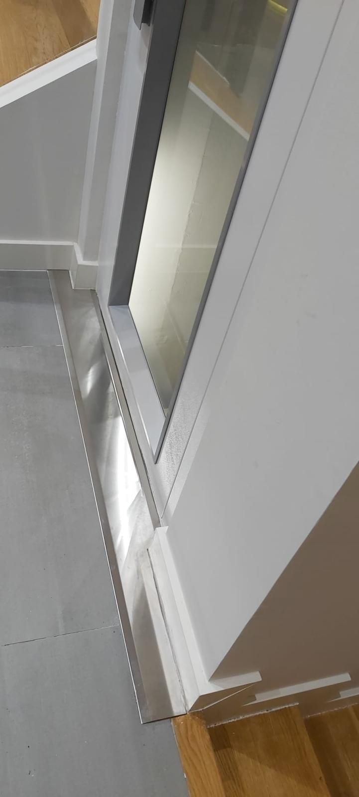 Un primer plano de una puerta con una ventana en una habitación.