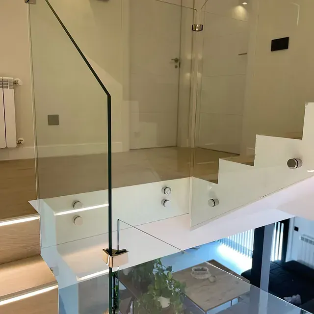 Una escalera con barandilla de cristal en una casa