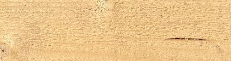 Eine Nahaufnahme eines Holzstücks mit einem Loch darin.