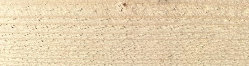 Eine Nahaufnahme eines Holzstücks, die die Maserung des Holzes zeigt.