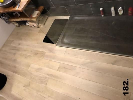 Ein Badezimmer mit Holzboden und Badewanne.