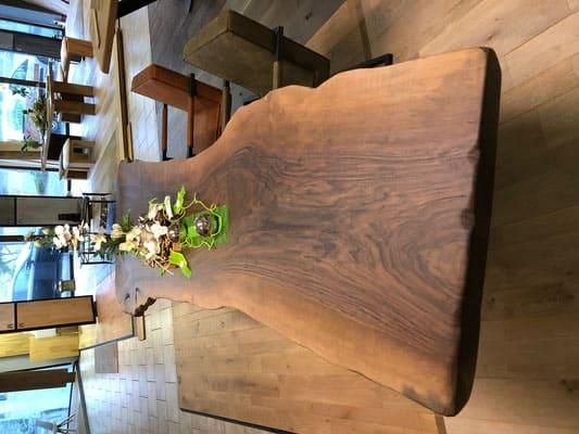 Ein Holztisch mit einer Vase mit Blumen darauf