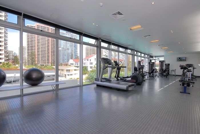 The gym facilities with windows and exercise equipment. In the q1 tower resort in surfers paradise