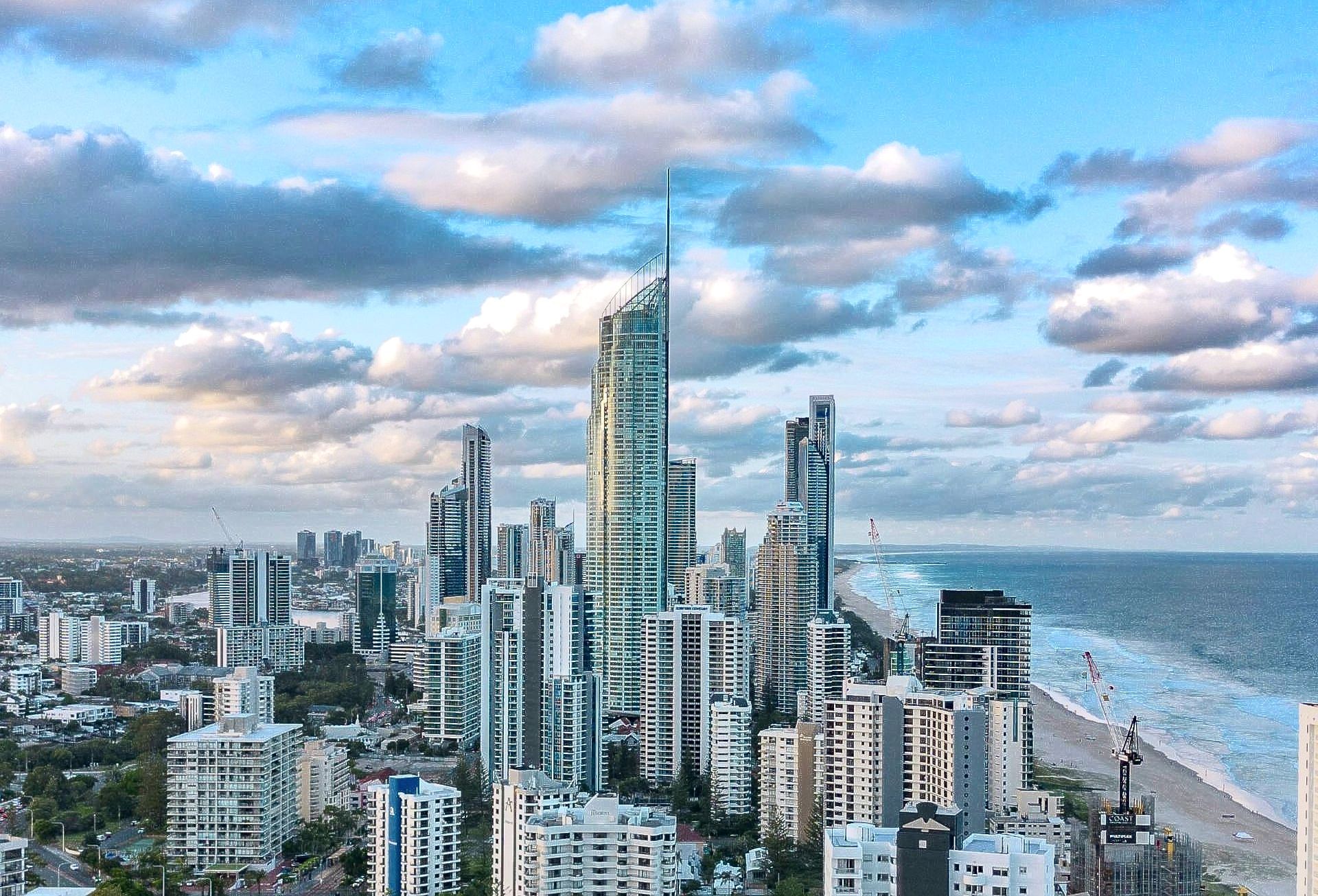 An beautiful view of a gold coast city with tall buildings and a beach.