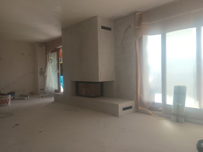 Un salon avec cheminée et une grande fenêtre.