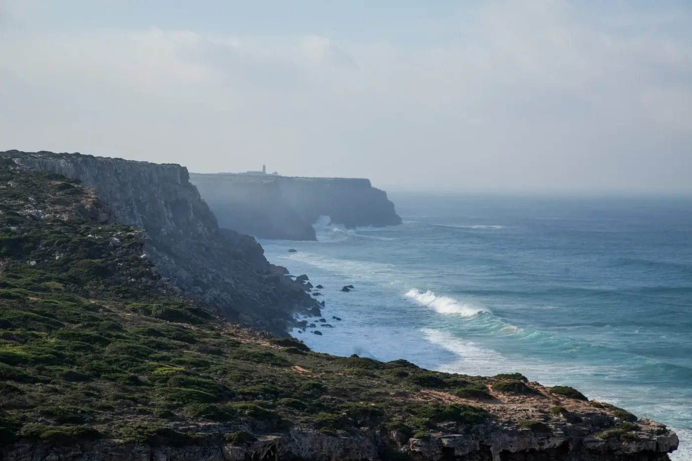 Una vista de un acantilado con vistas al océano en un día nublado.