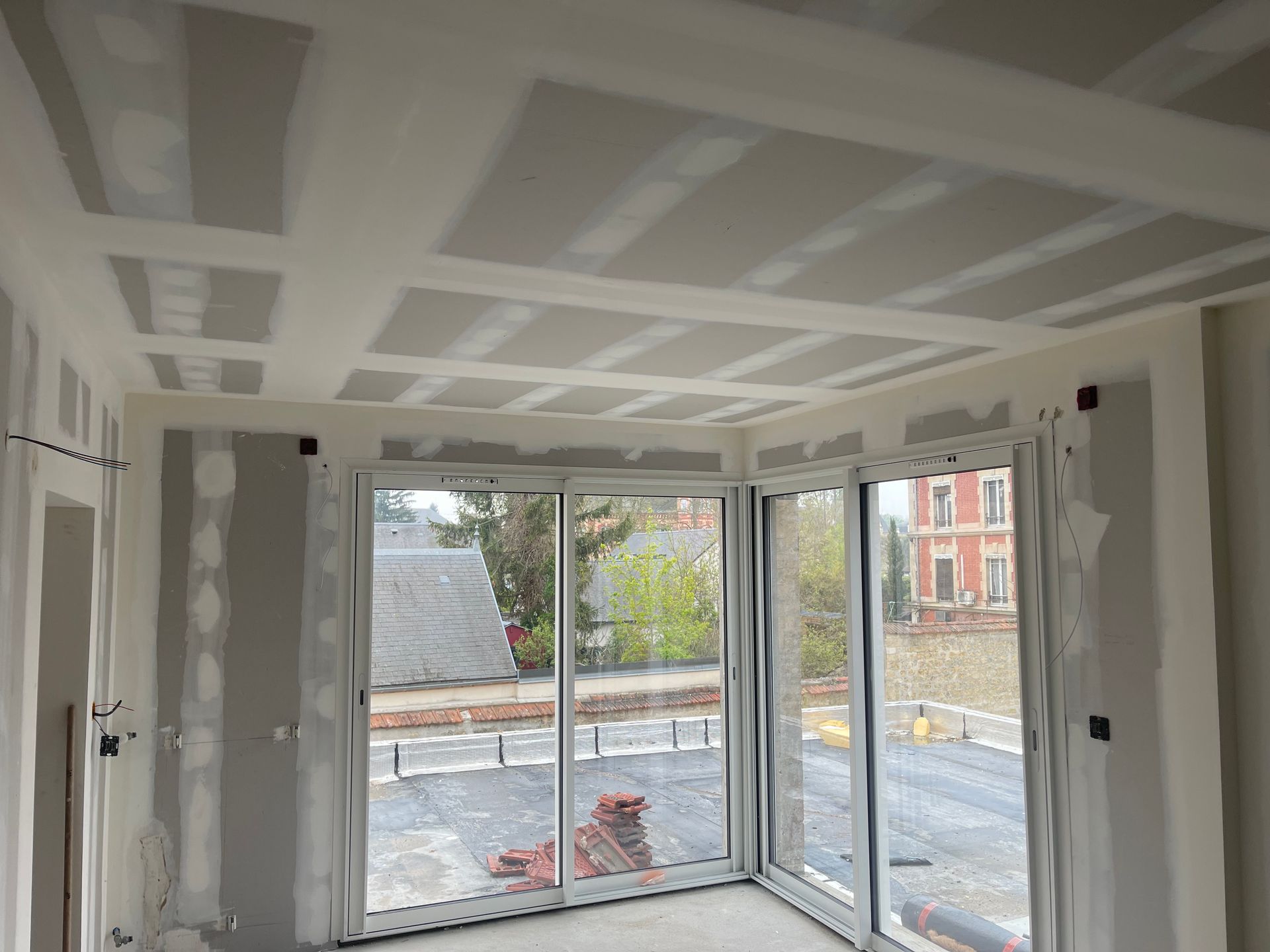Plafond et cloison en plaques de plâtre avec baie vitrée
