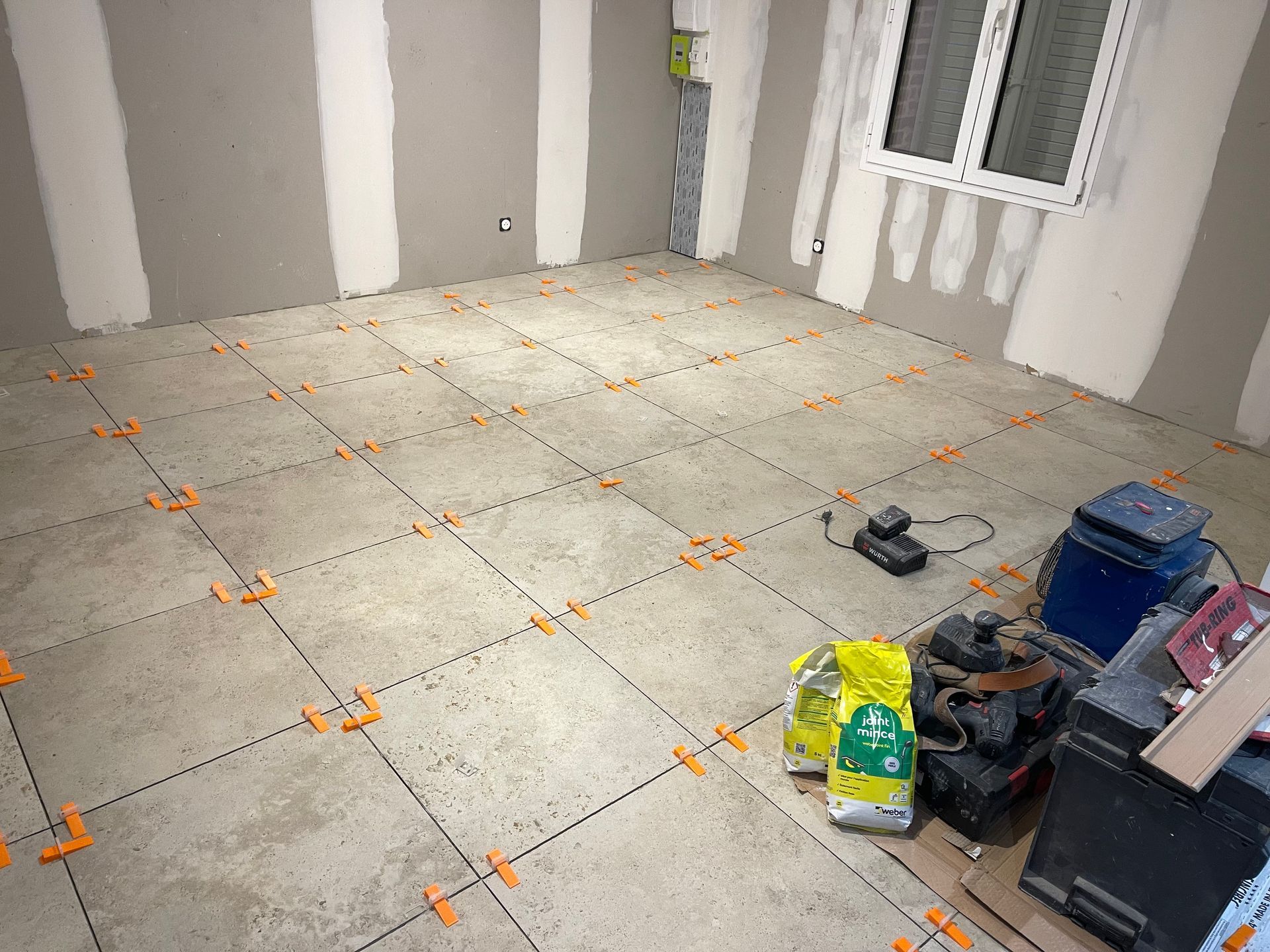 Pose de carrelage travertin en cours