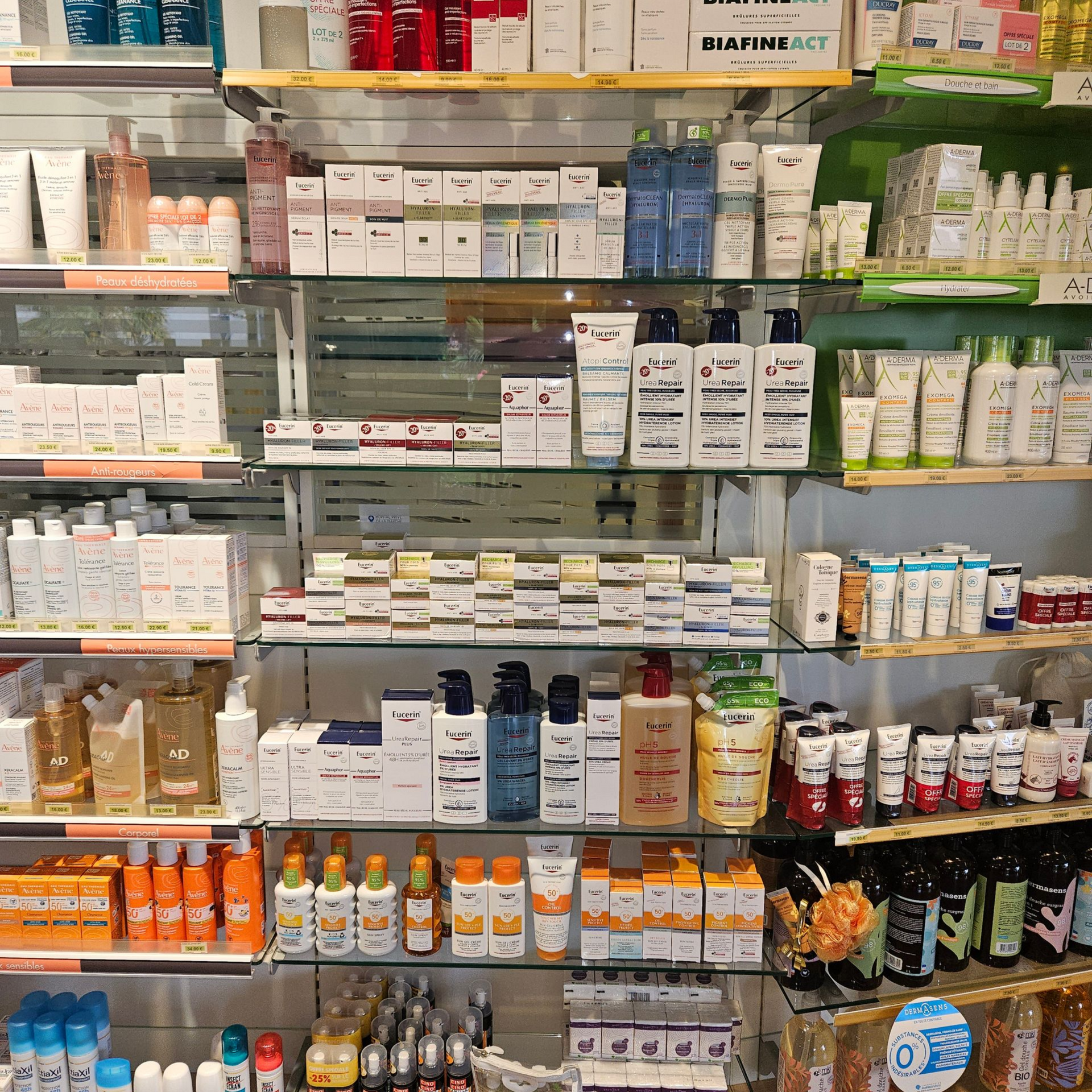 Rayons de médicaments et de compléments alimentaires variés dans une allée de pharmacie