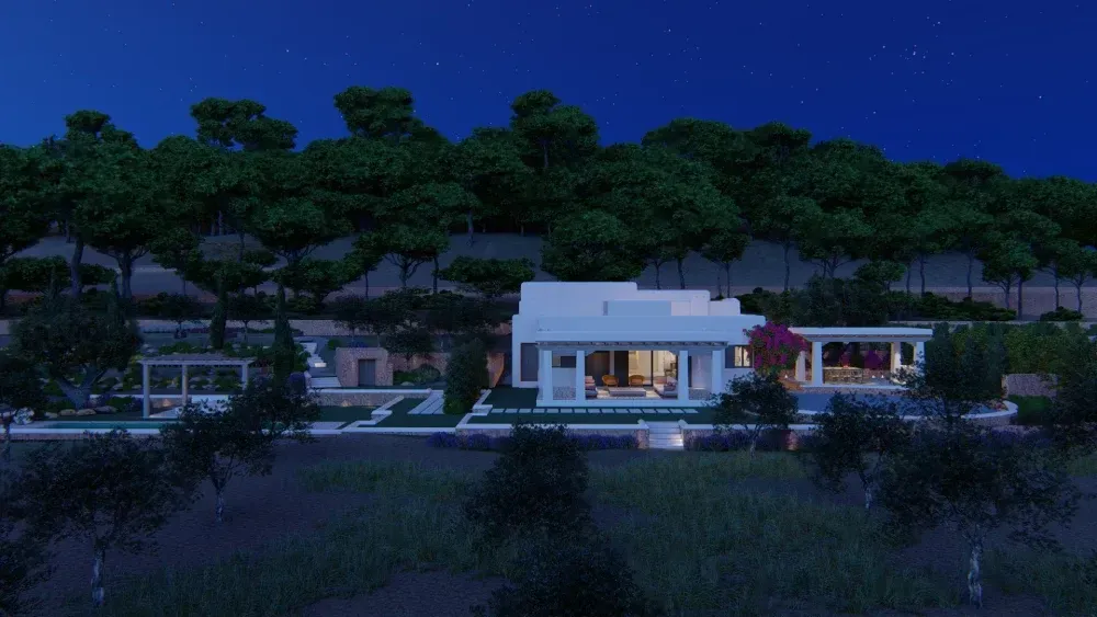 Una casa blanca está rodeada de árboles por la noche.