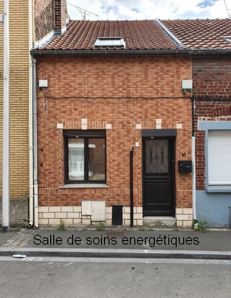 Personne allongée recevant un soin énergétique avec mains placées au-dessus du visage.