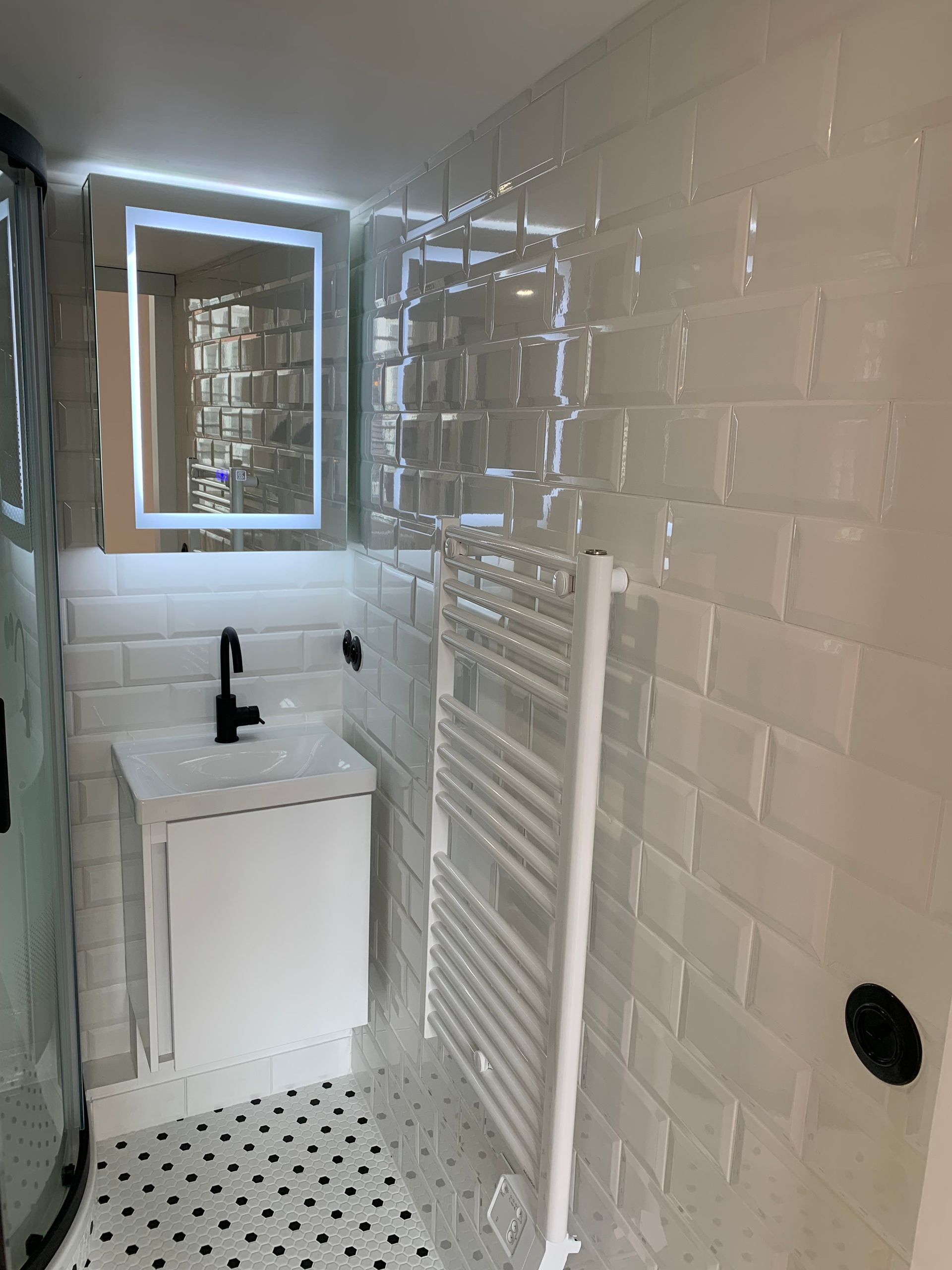 Salle de bains dans un studio avec carrelage style métro