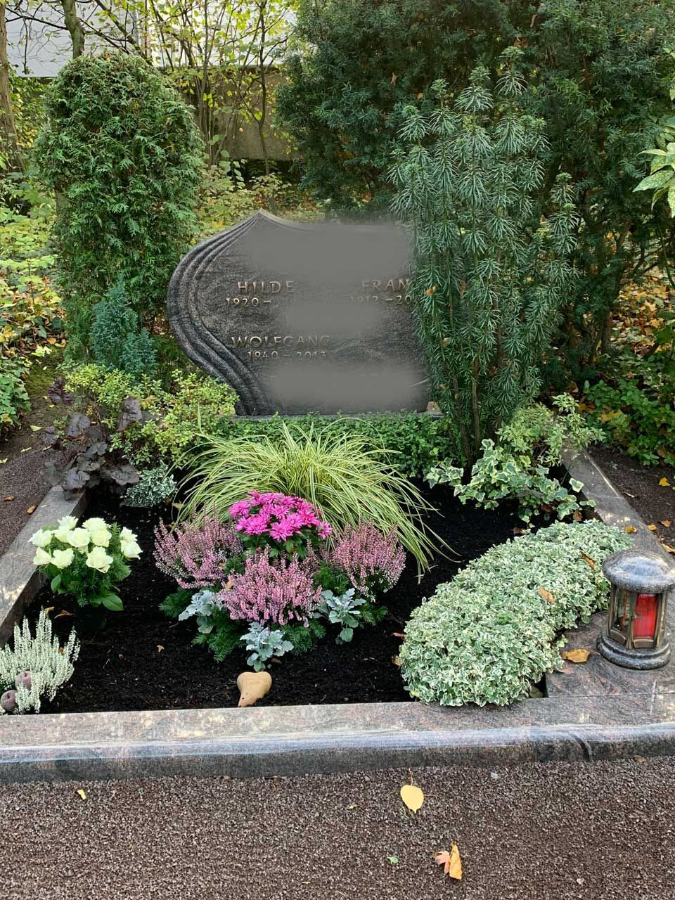 Ein Friedhof voller Blumen und Pflanzen.