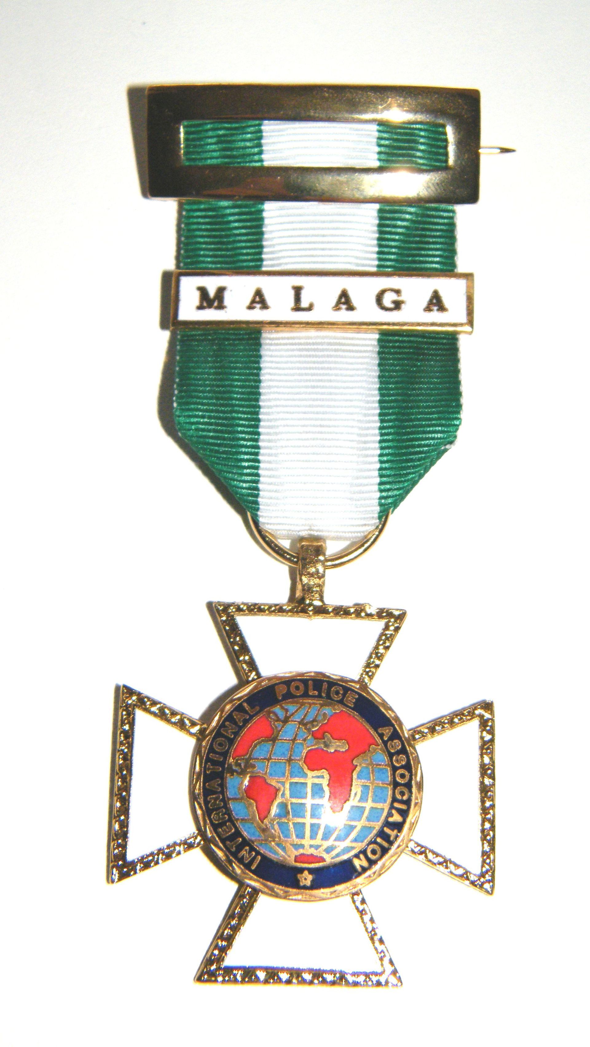 Una medalla con la palabra Málaga.