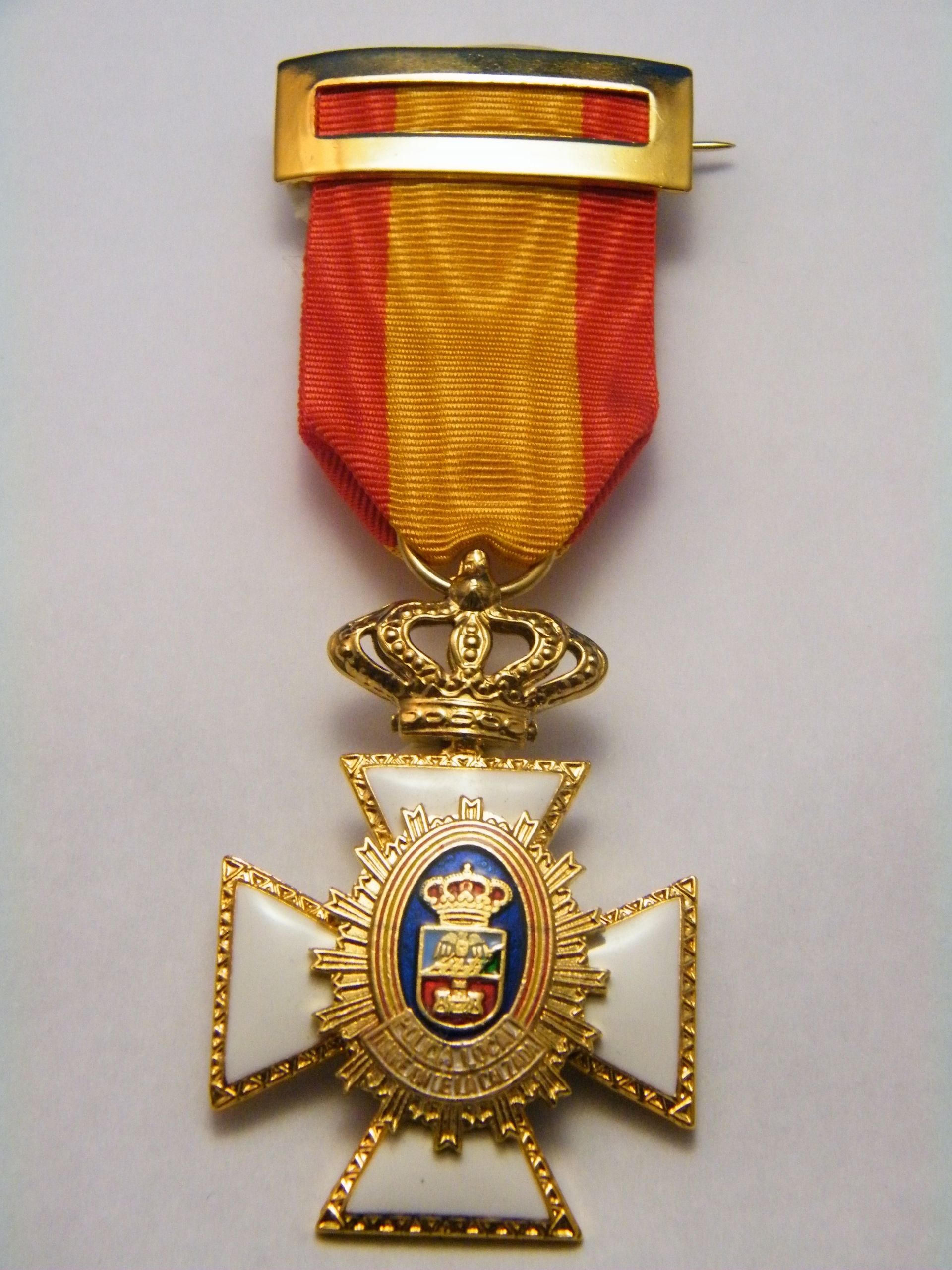 Una medalla con la palabra España.