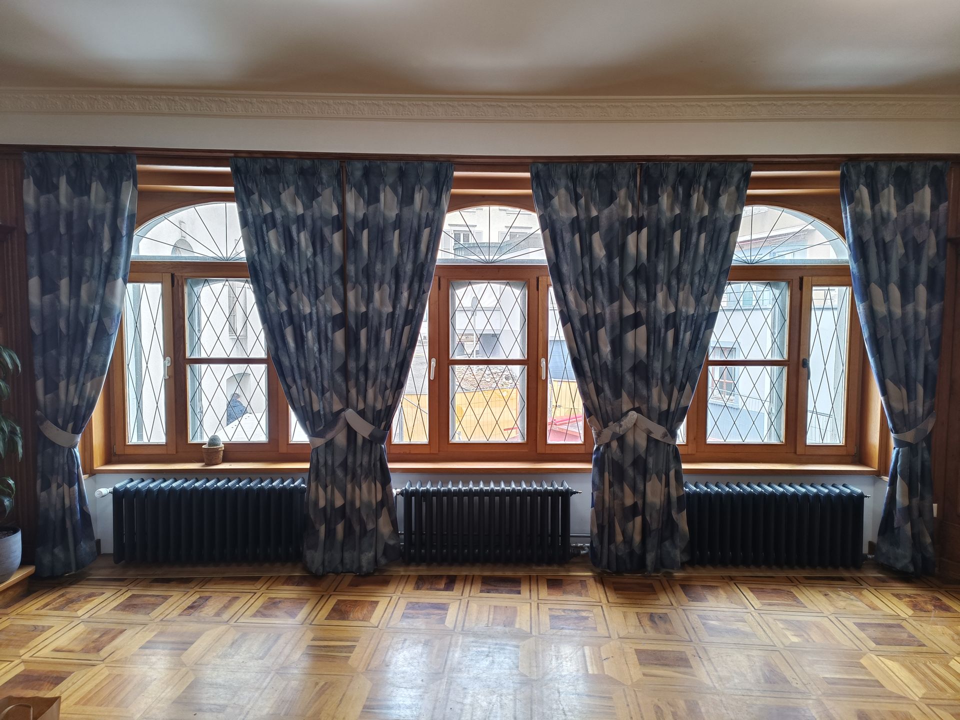 Il y a deux rideaux sur la fenêtre de la pièce.