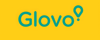 Logotip de Glovo amb text verd i un signe d'exclamació en forma de xinxeta al mapa sobre un fons groc.