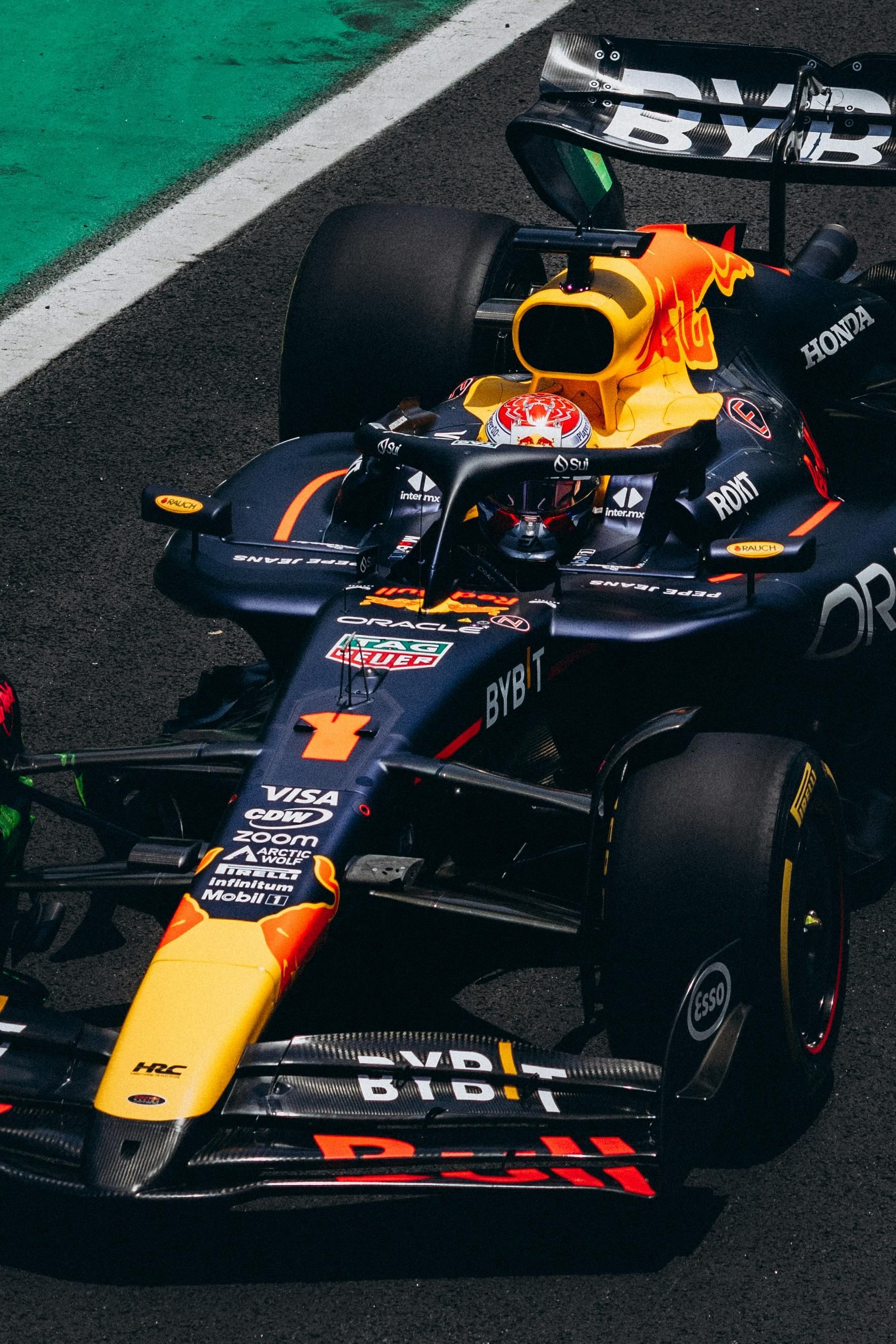 Red Bull Formula 1 car on a track; navy, yellow and red livery.