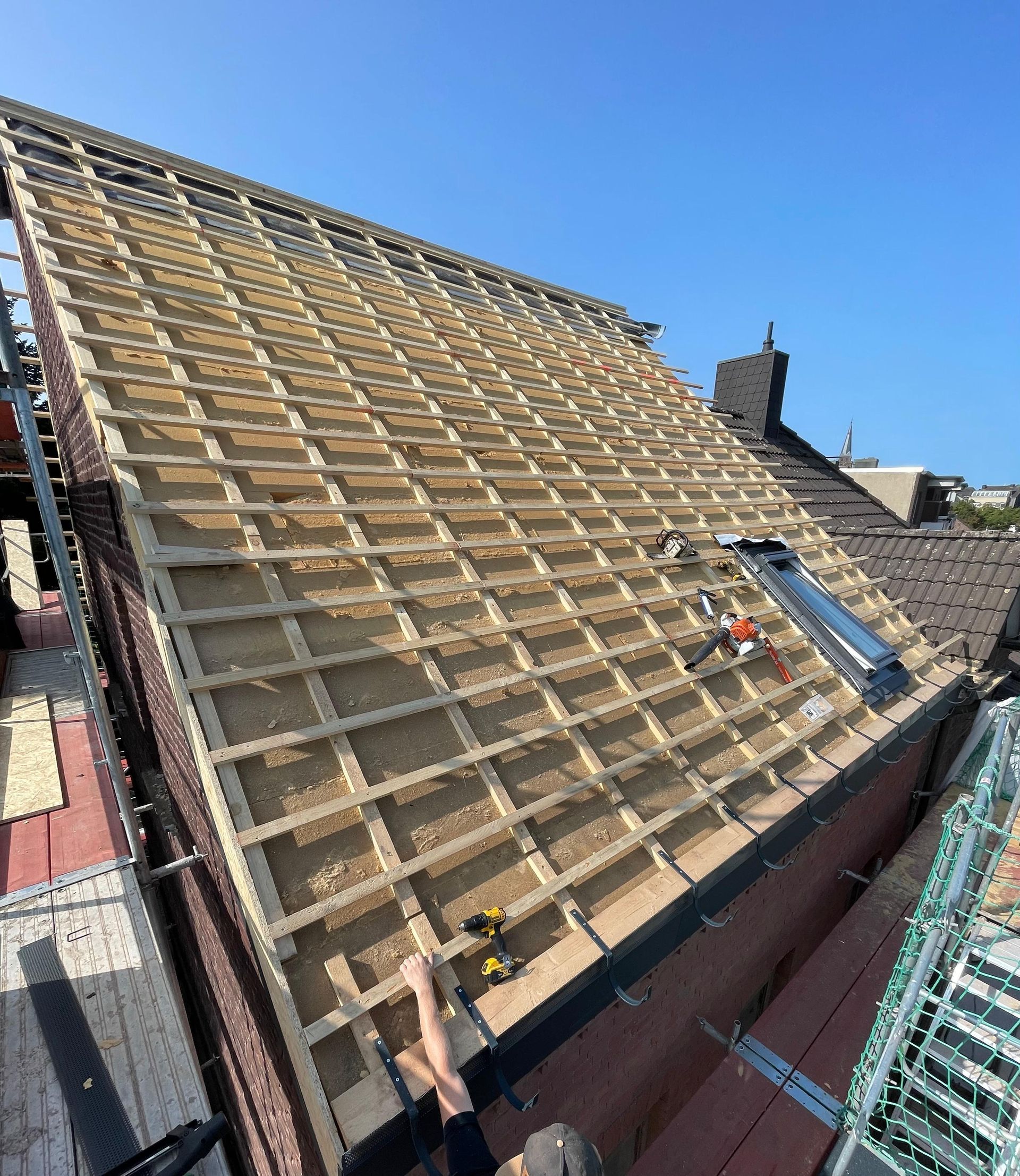 Ein Mann arbeitet auf dem Dach eines Gebäudes.