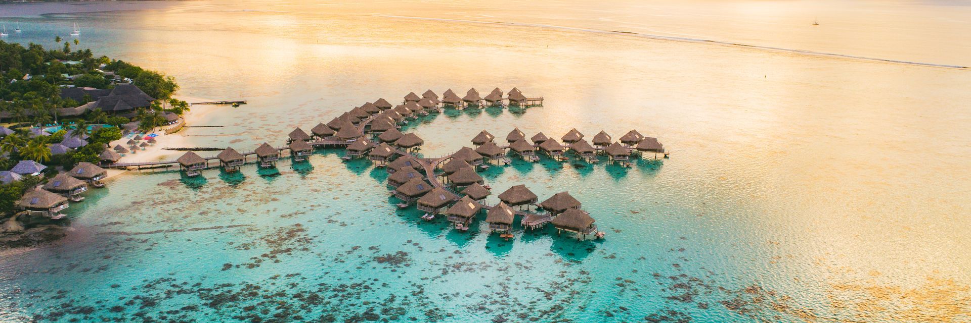 An aerial view of a tropical island in the middle of the ocean.