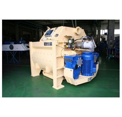 Gran máquina industrial de color beige con motores azules en un taller de fábrica.