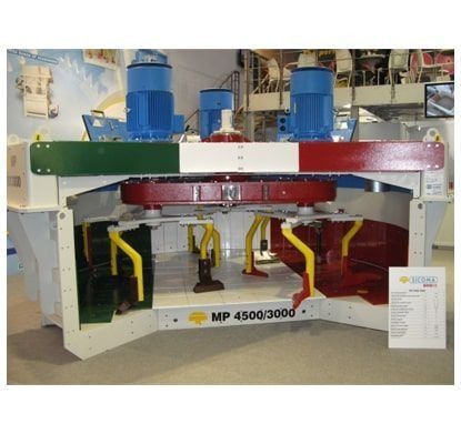 Máquina industrial con motores azules y componentes rojos, etiquetada como MP 4500/3000, expuesta en interiores.