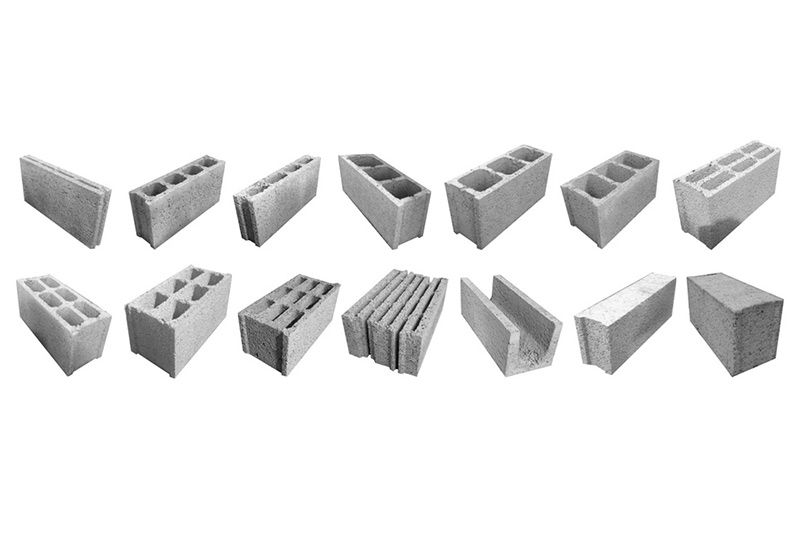 Un montón de diferentes tipos de bloques de hormigón sobre un fondo blanco.
