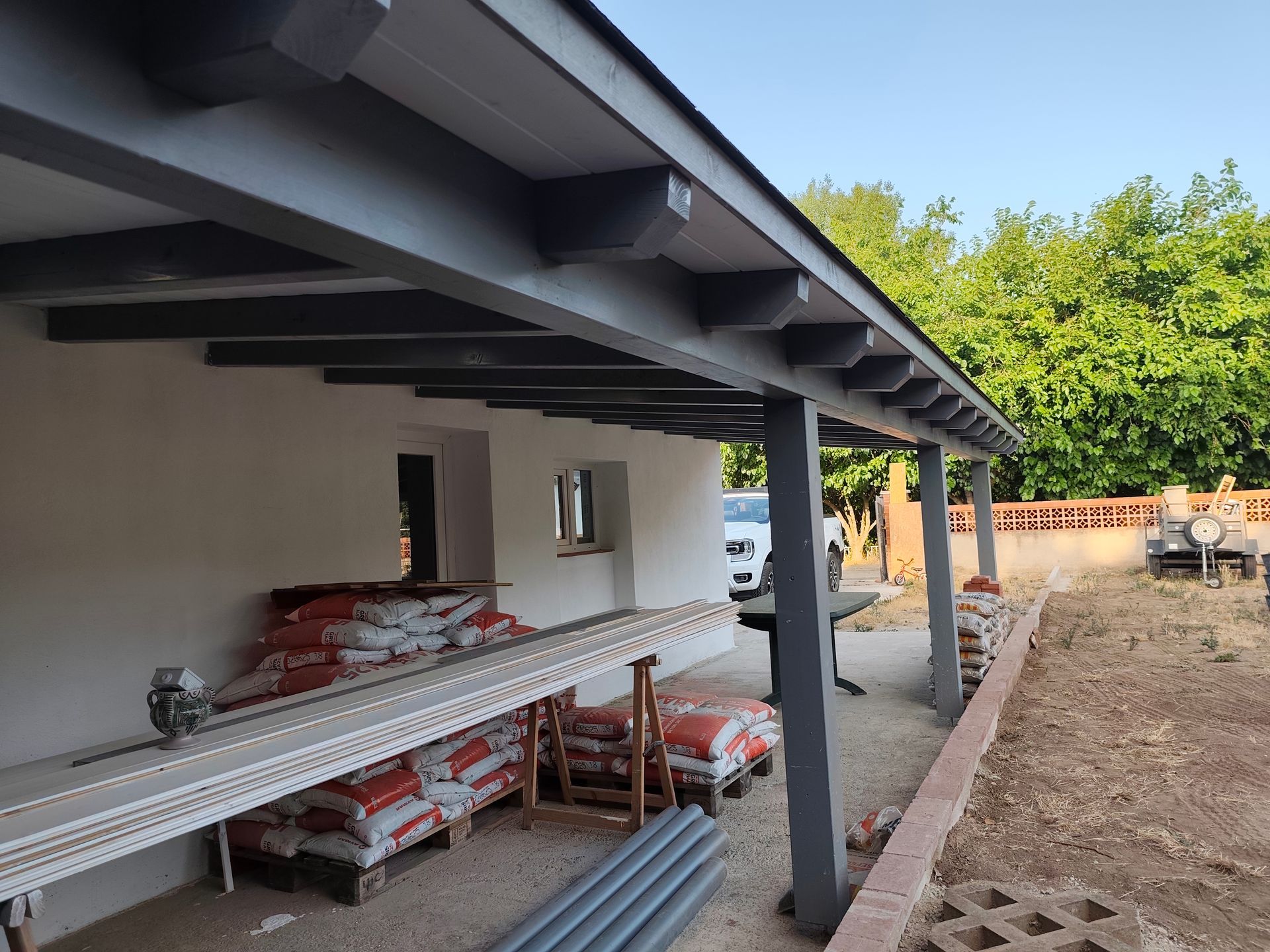 Un edificio en construcción con muchos sacos de cemento en el suelo.