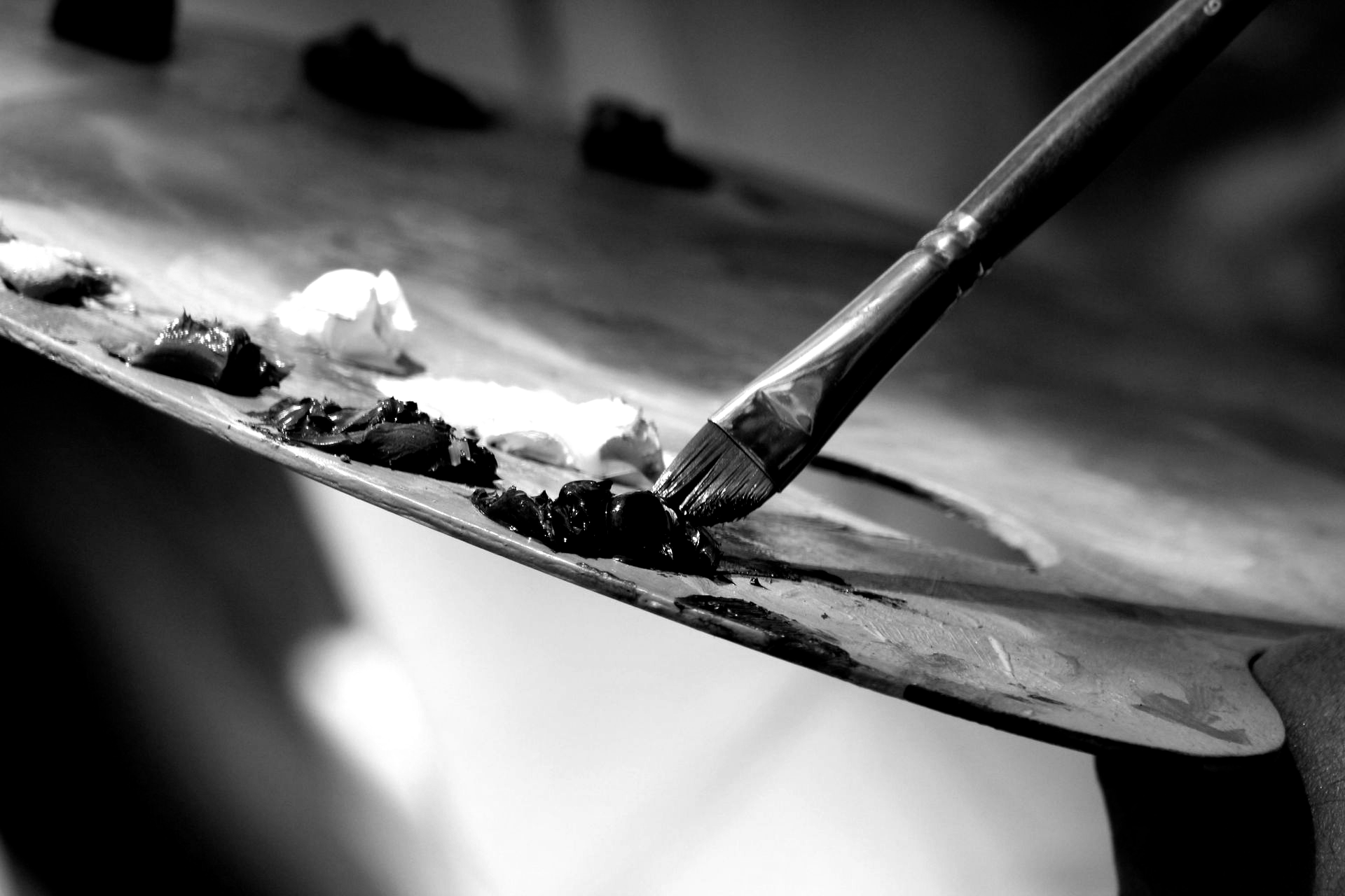 Paintbrush on a palette, mixing paint.