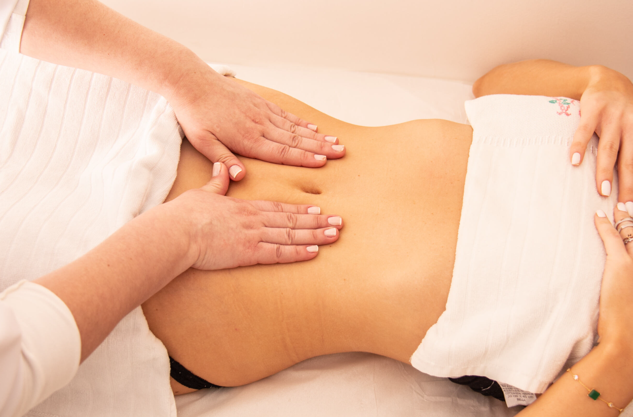 Una mujer está recibiendo un masaje en el estómago.