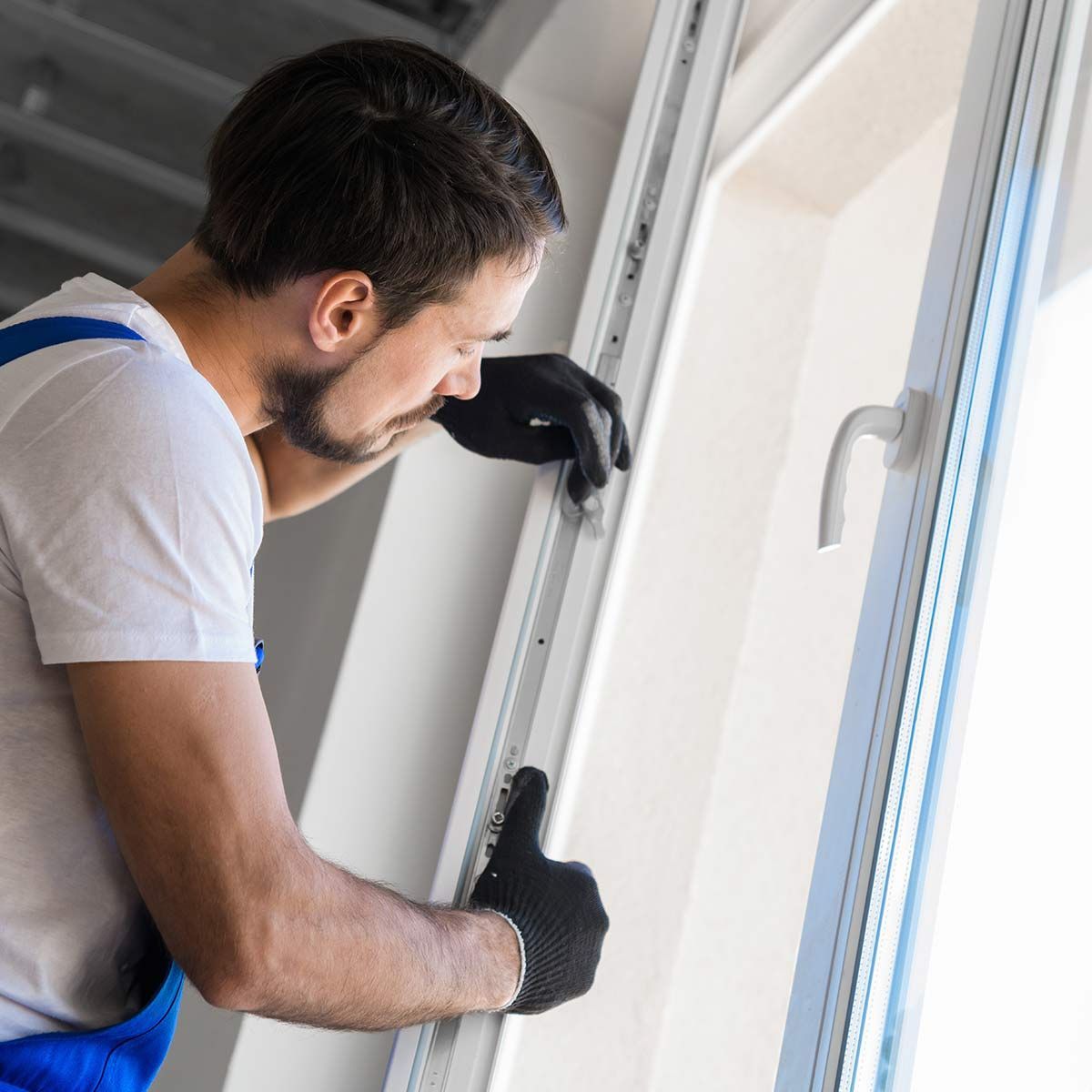 Artisan qui installe une fenêtre