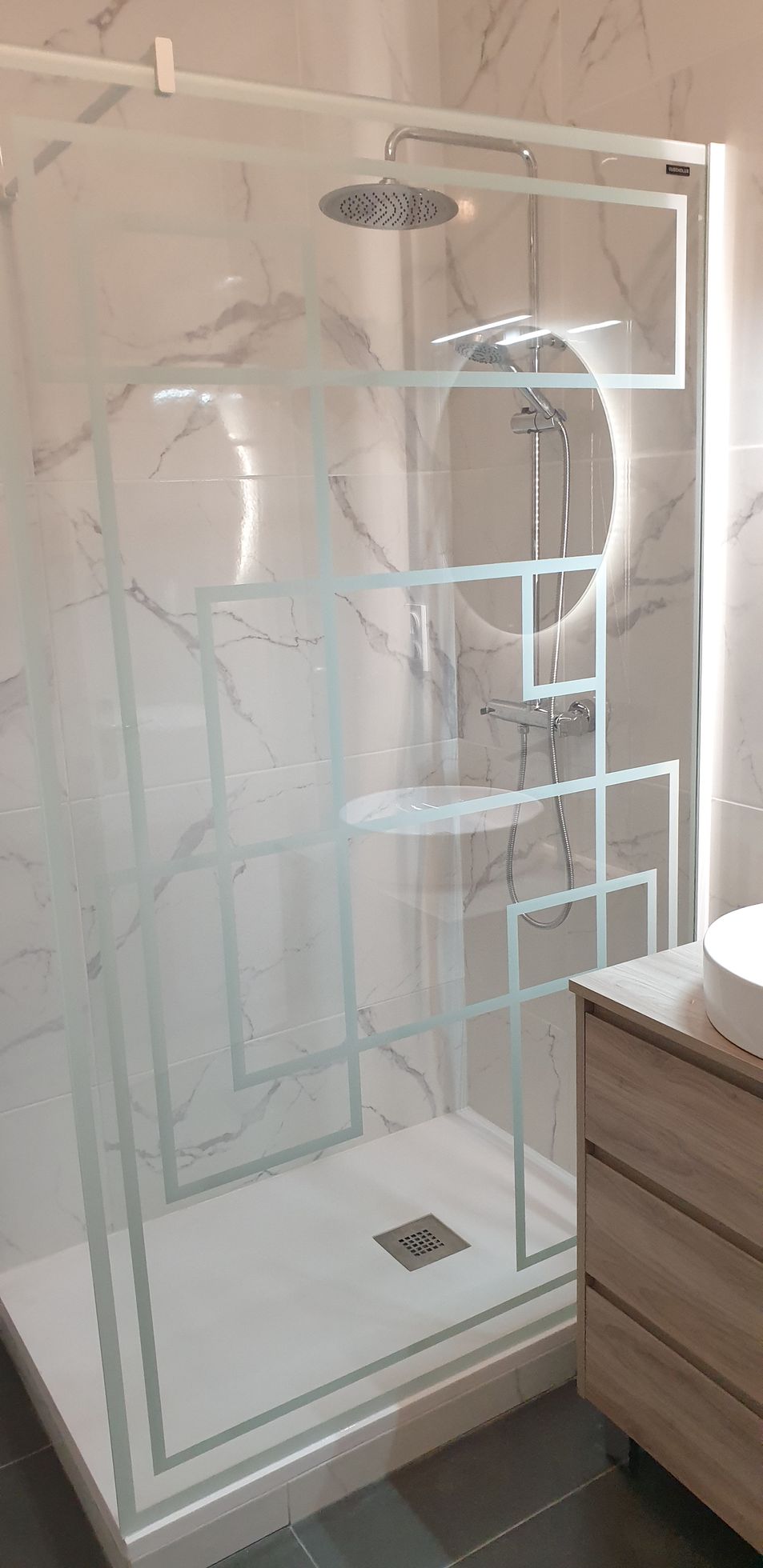 Douche moderne avec une paroi vitrée à motifs géométriques