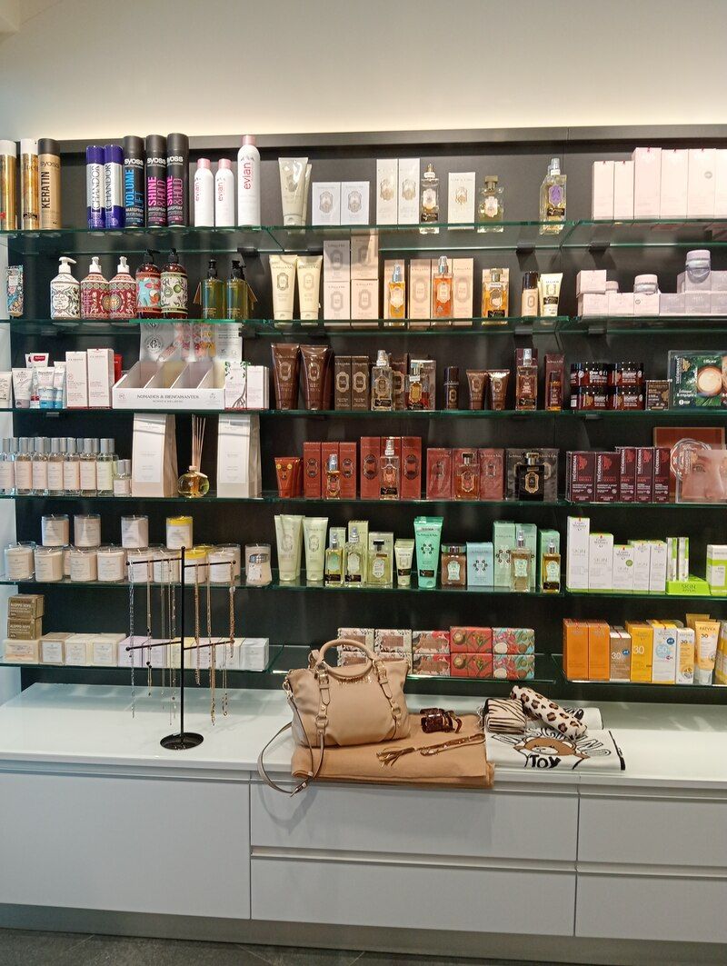 Un magasin rempli de nombreux produits cosmétiques et d'un sac à main sur un comptoir.