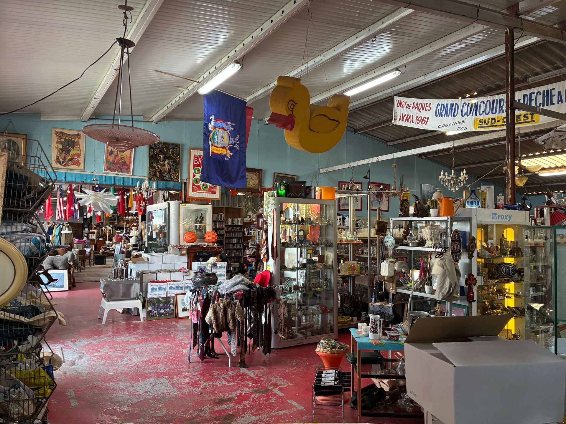 Intérieur d'un magasin d'antiquités encombré, décoré d'un canard en caoutchouc géant.