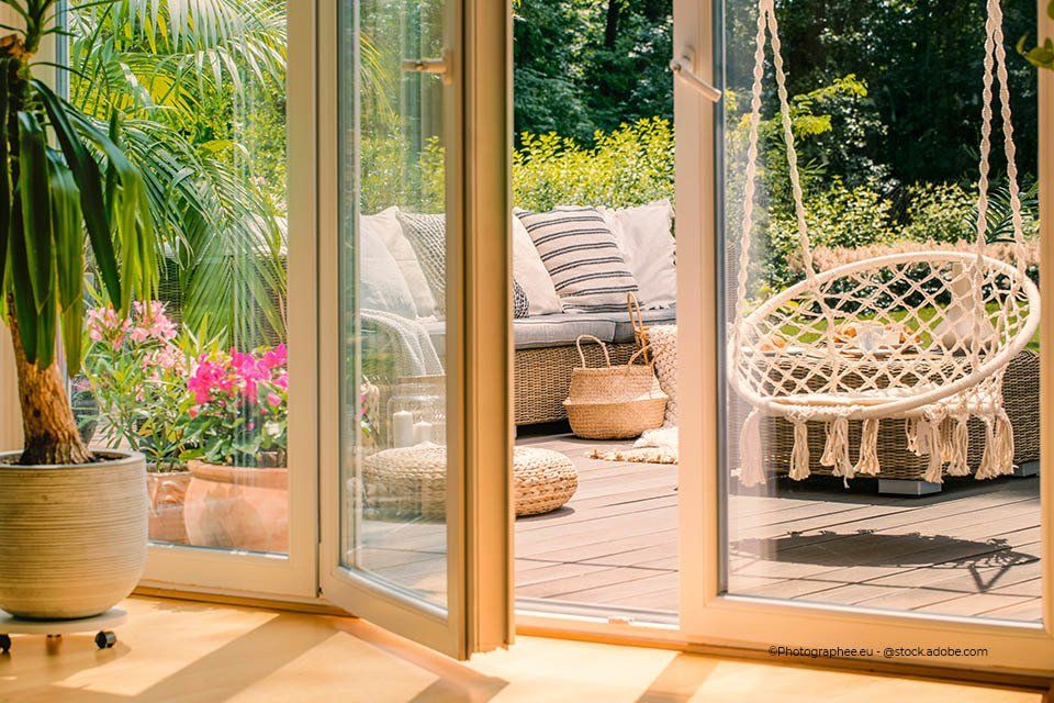 Kind schließt Glasschiebetür der Firma GLAS & SPIEGEL Niederrhein GmbH, die in den Garten führt