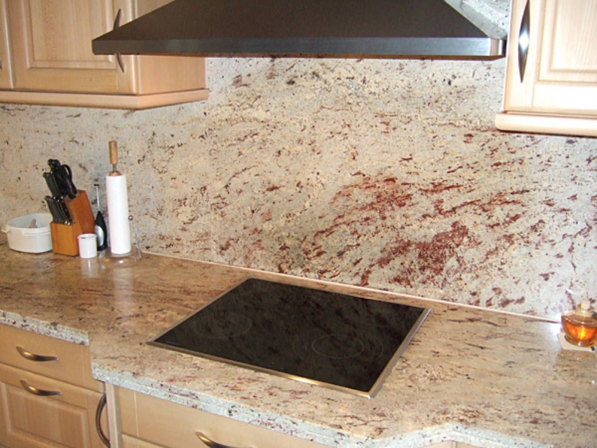 Eine Küche mit Granitarbeitsplatten und einem Herd,  Scharwat - Fliesen und Naturstein