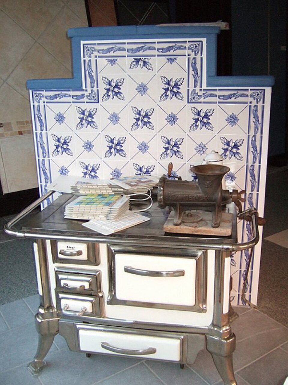 Ein Herd mit blau-weißen Kacheln dahinter, Scharwat - Fliesen und Naturstein