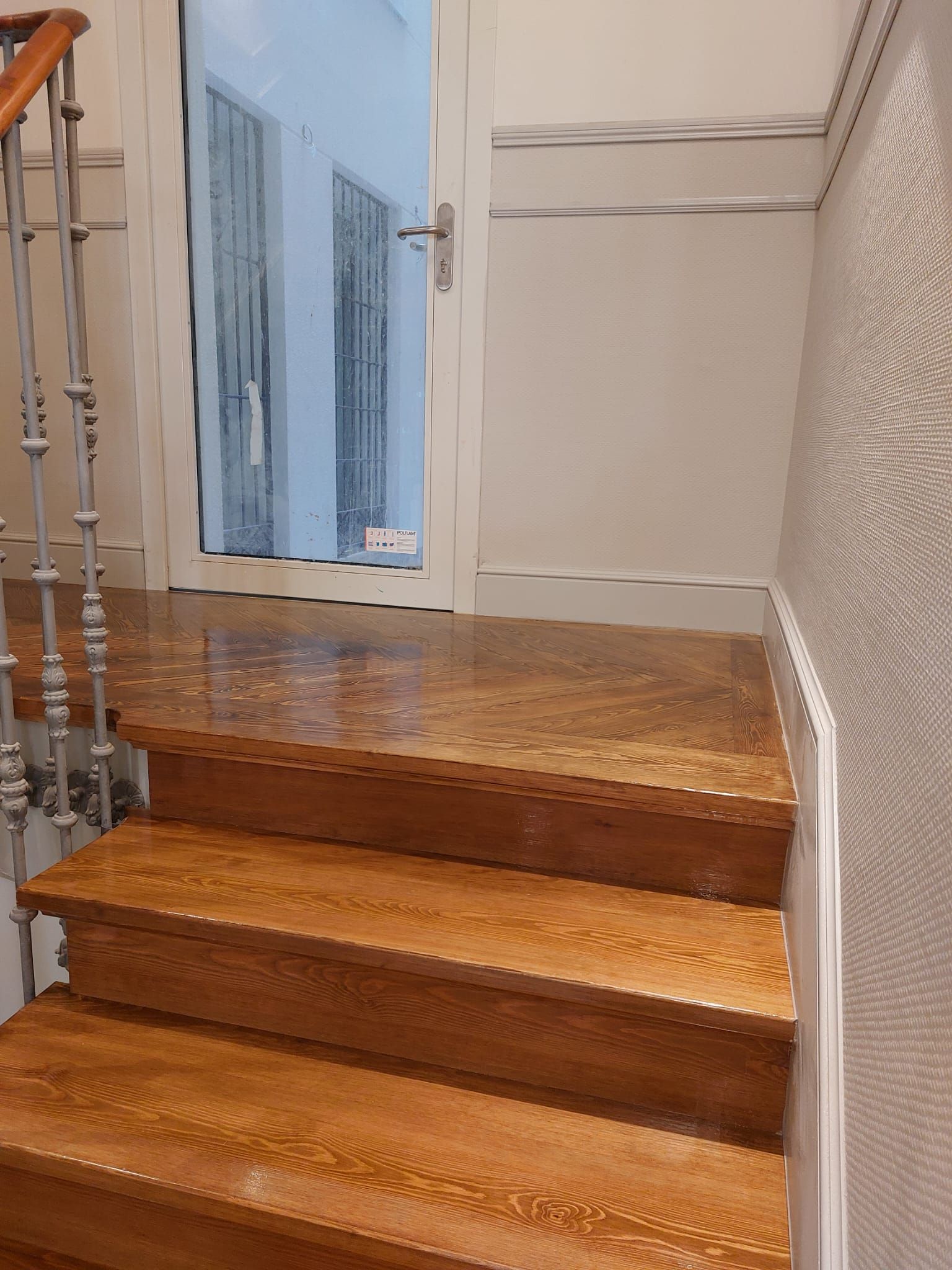 Un conjunto de escaleras de madera que conducen a una puerta.