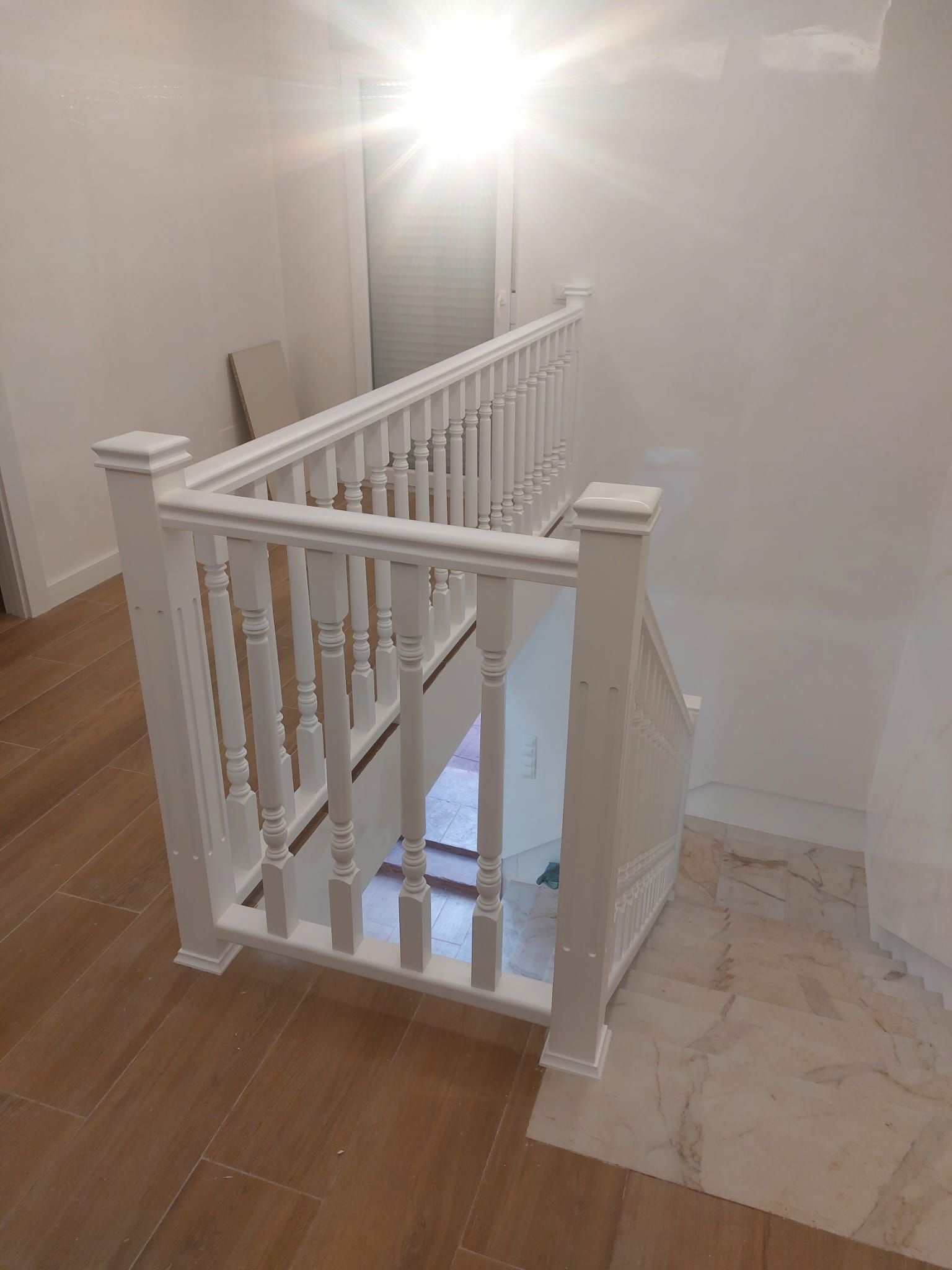 Una barandilla blanca en un conjunto de escaleras de una casa.