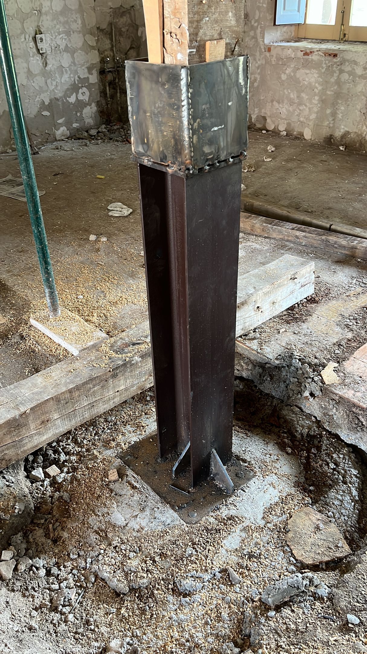 Un poste de metal está sentado en el medio de un agujero en el suelo.