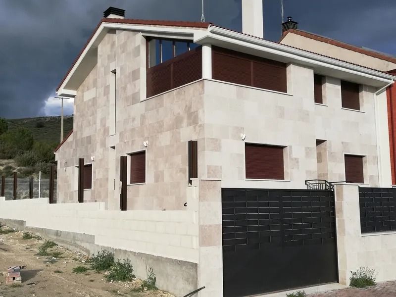 Una gran casa blanca con una puerta negra delante.