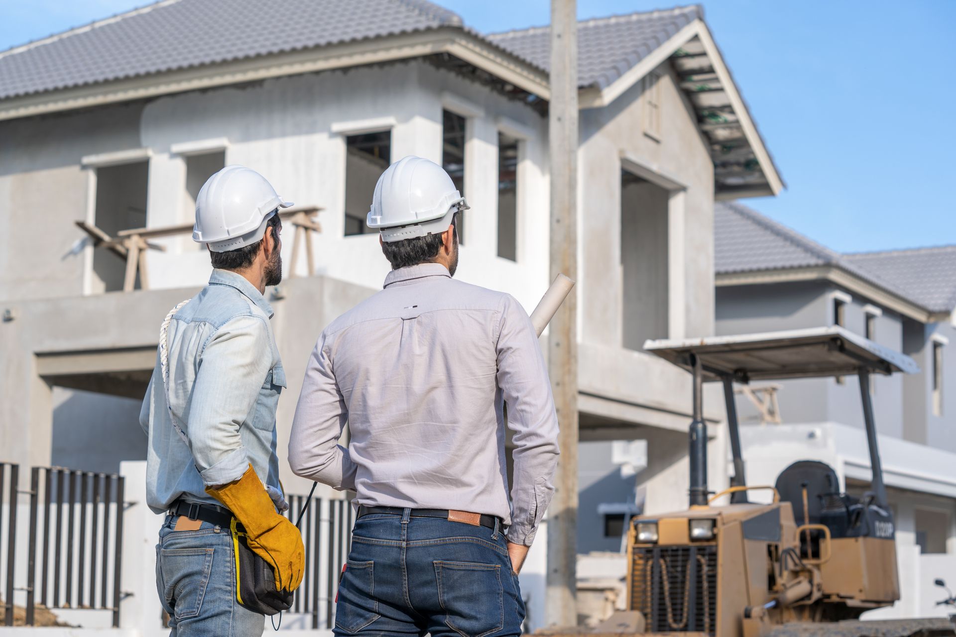 Deux personnes côte à côte devant un chantier de construction de maison