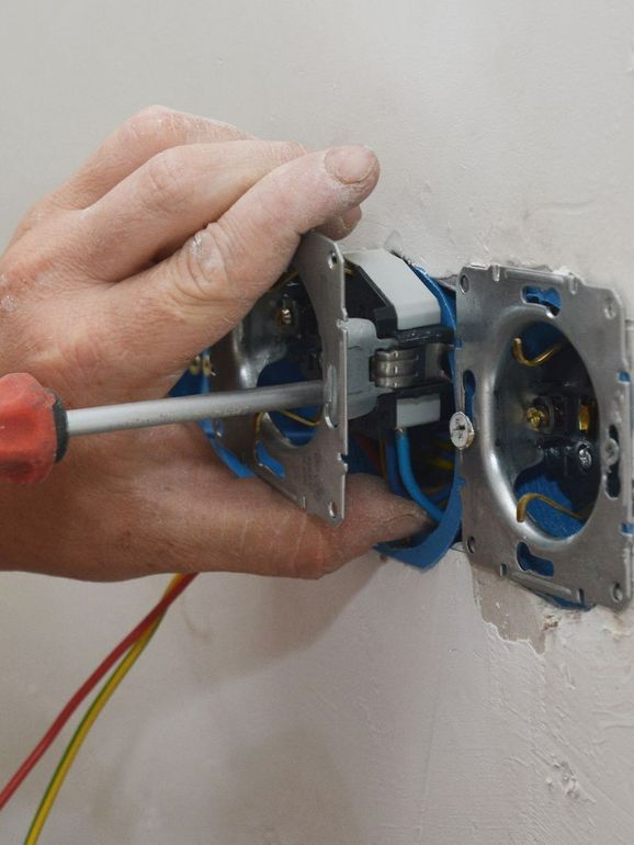 Pose d'une prise électrique avec un tournevis