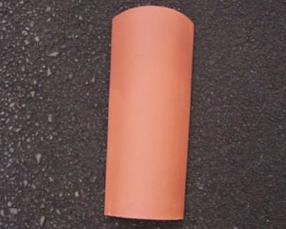 Un tubo largo de color naranja se encuentra en el suelo.