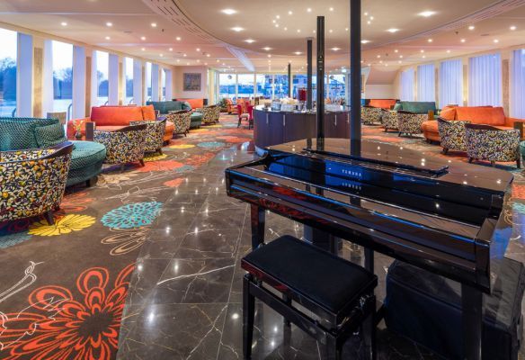 there is a piano in the middle of the lounge onboard AmaKristina