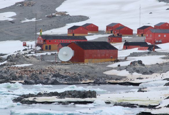 A red building with a satellite dish on top of it