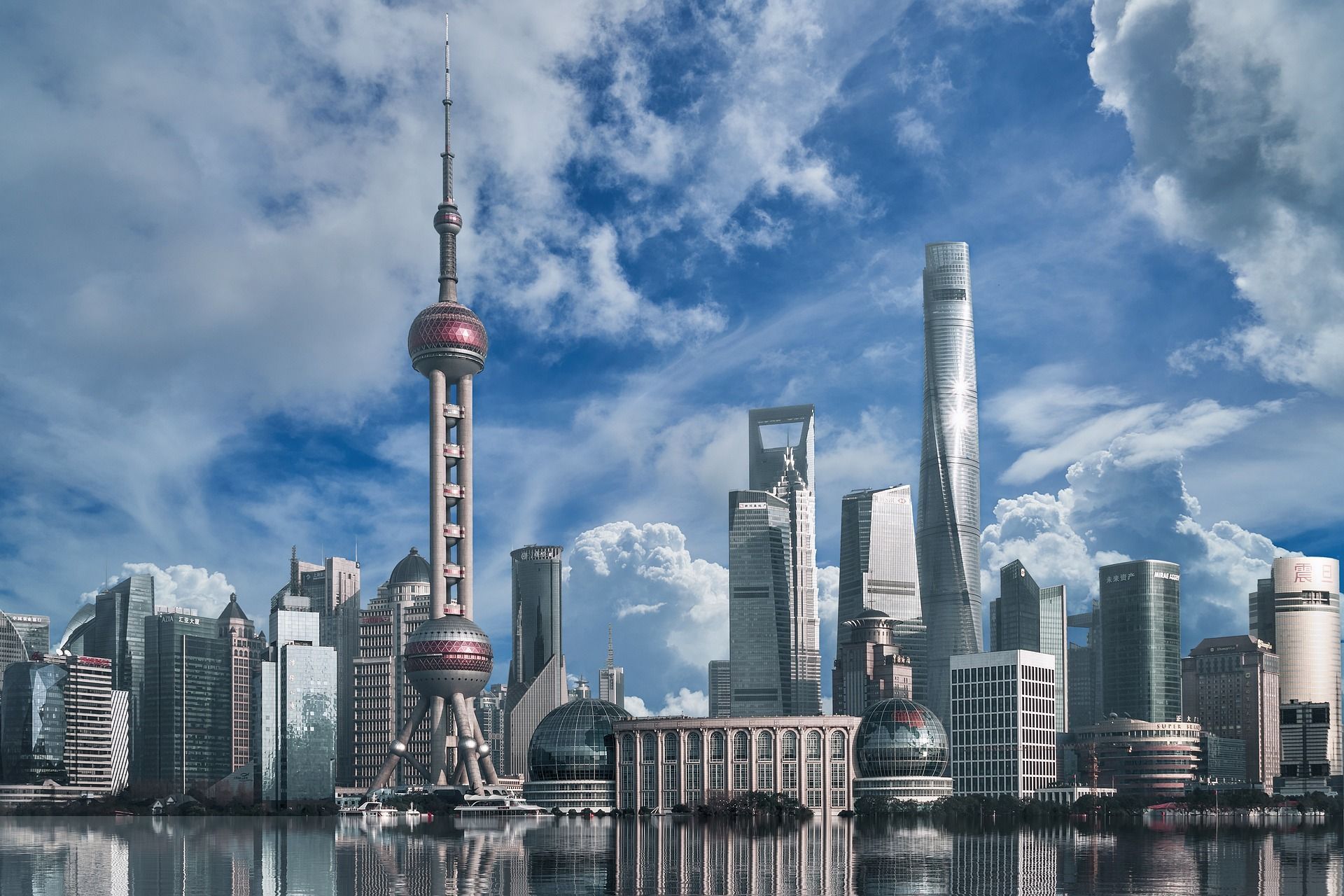 The skyline of shanghai is reflected in the water.