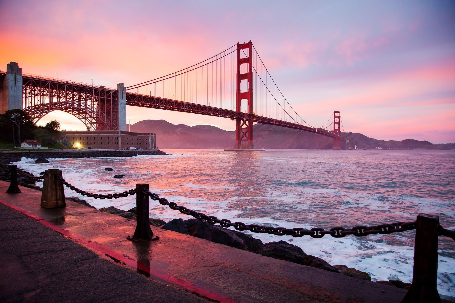 golden gate bridge over a body of water with a sunset in the background  on Azamara 2027 World Cruise